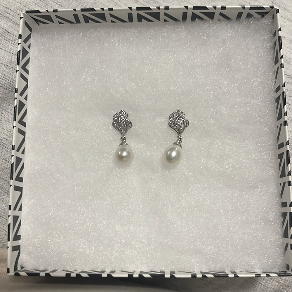 Dangling pearl earring. Missing one teeny tiny stone. Barely noticeable.